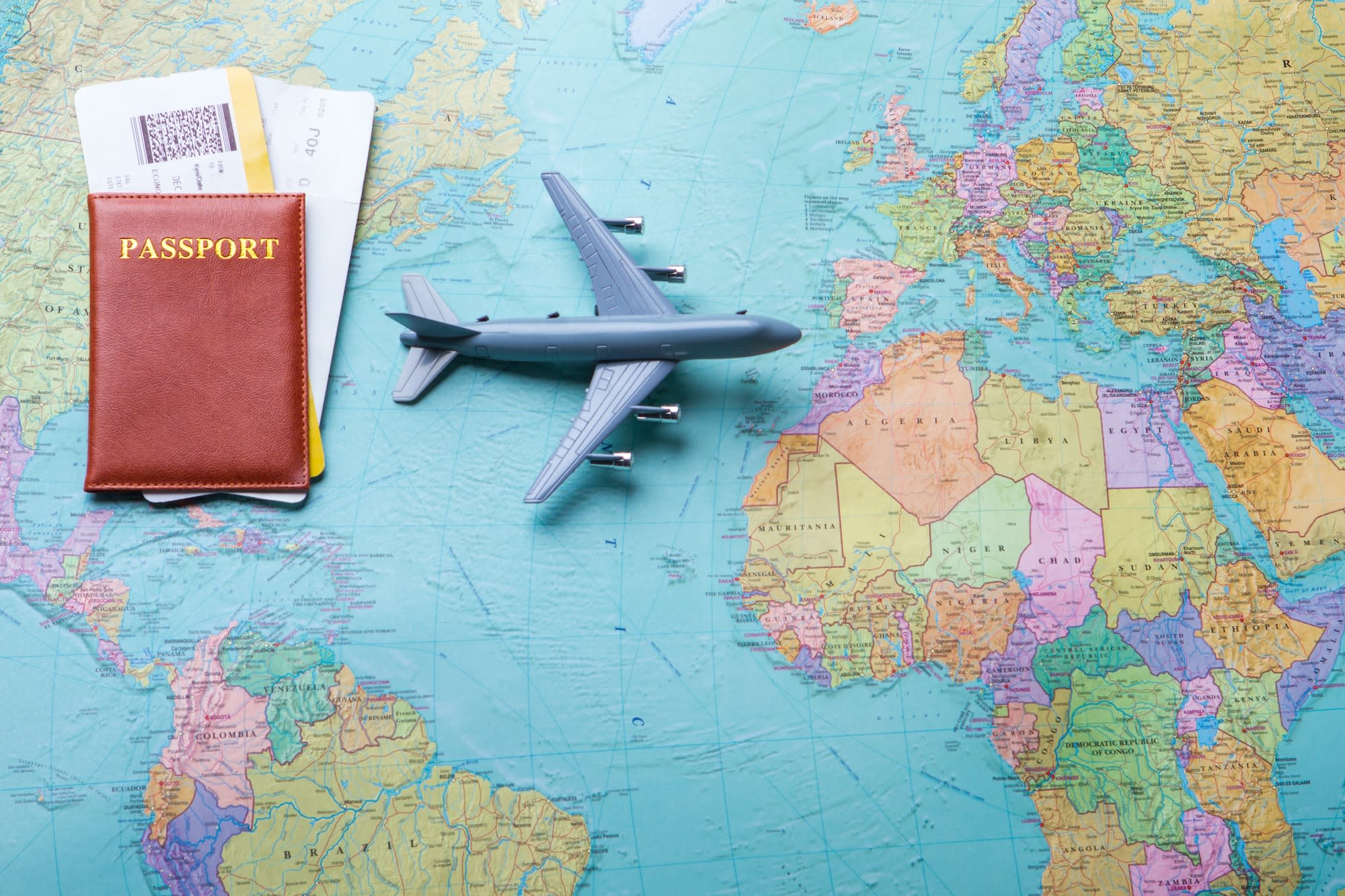 Passport and flight tickets on a map